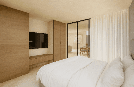 A close-up of a beige-colored laptop with a smooth, matte finish on a matching surface.