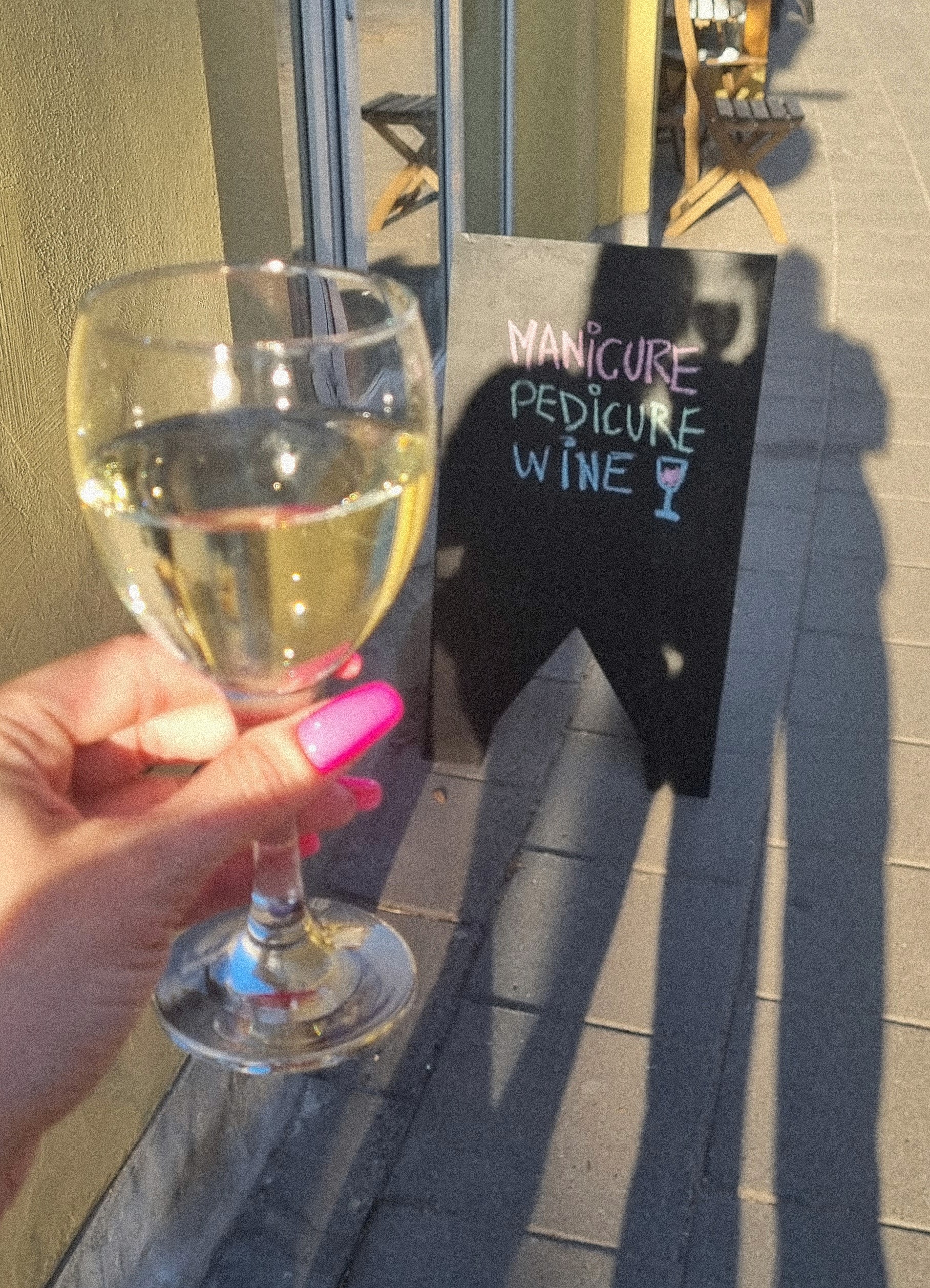 Hand with glittery pastel nails in sunlight