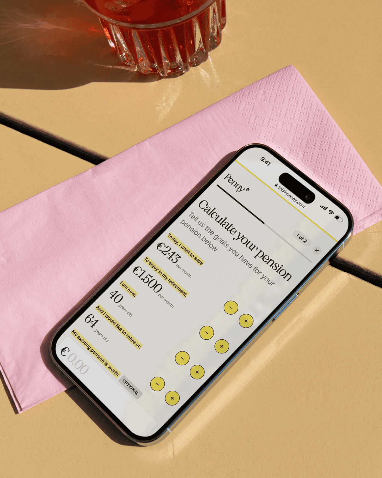 Penny app on a smartphone showing pension calculation settings, placed on a pink napkin.