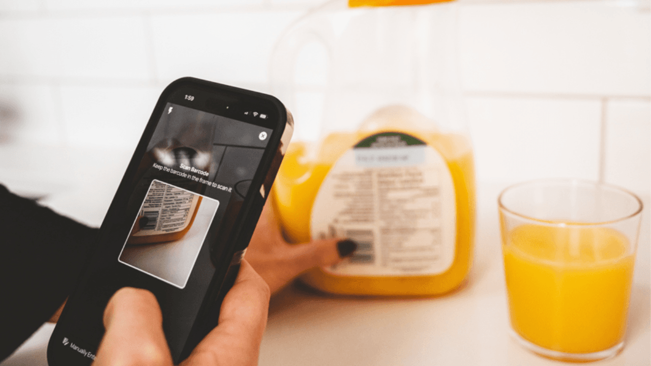 scanning the barcode of an orange juice bottle