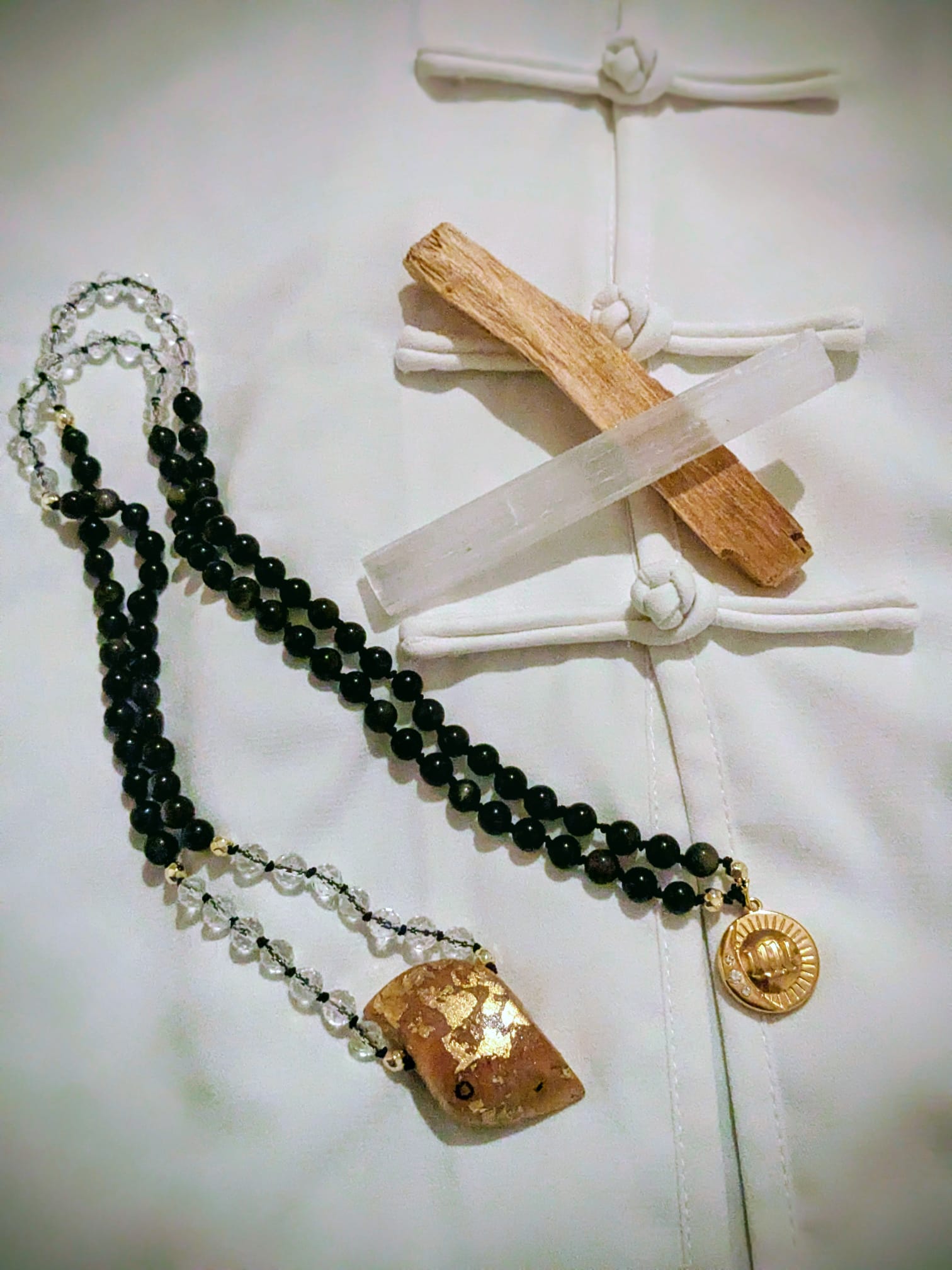 A wooden essential oil diffuser releasing a gentle stream of steam, surrounded by dried herbs and a small bottle of essential oil. The warm lighting enhances the cozy and therapeutic ambiance.