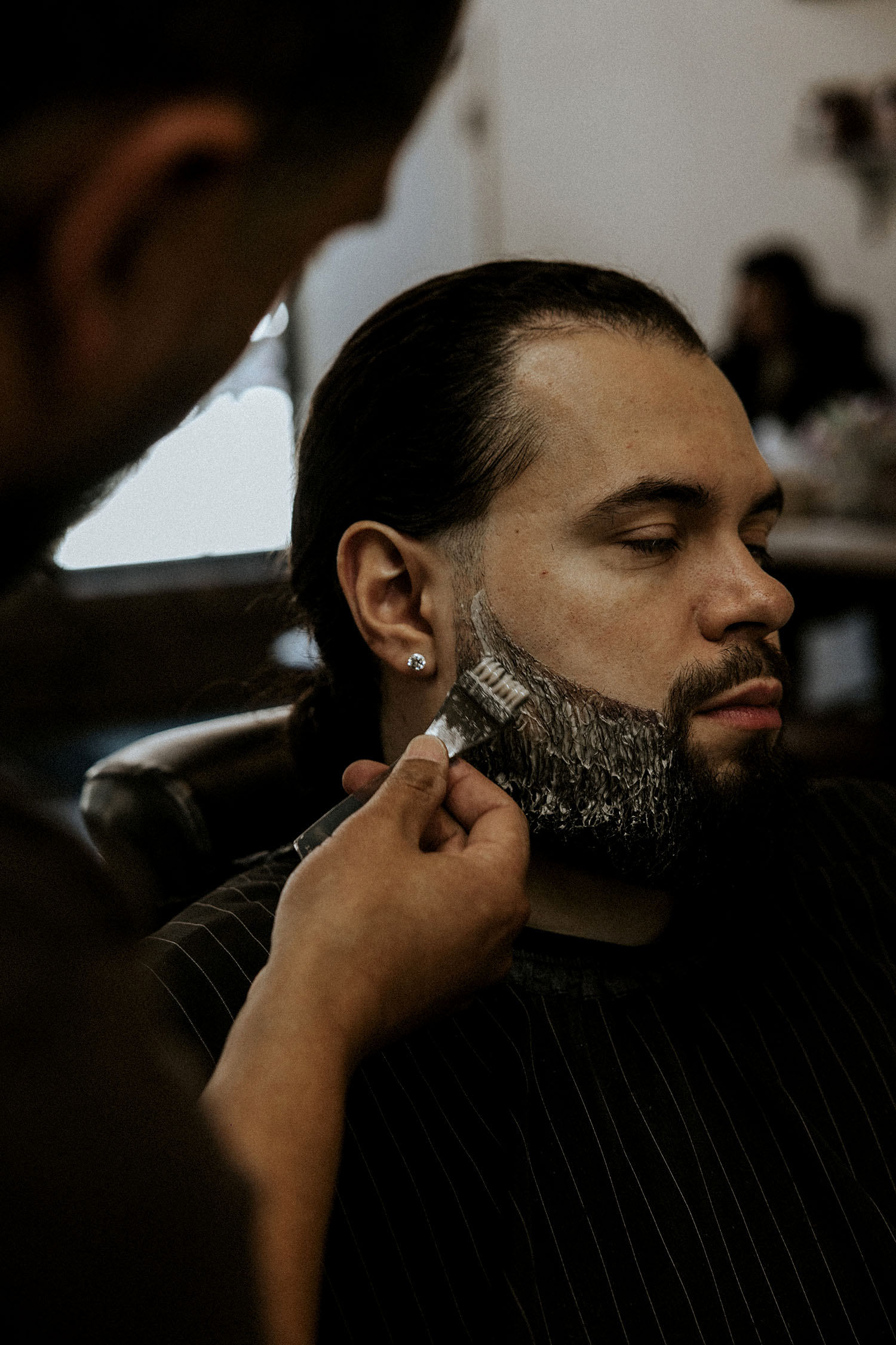 Lifestyle photo from Old Town Barber in Chicago capturing a precision beard treatment and the artistry behind modern men’s grooming.