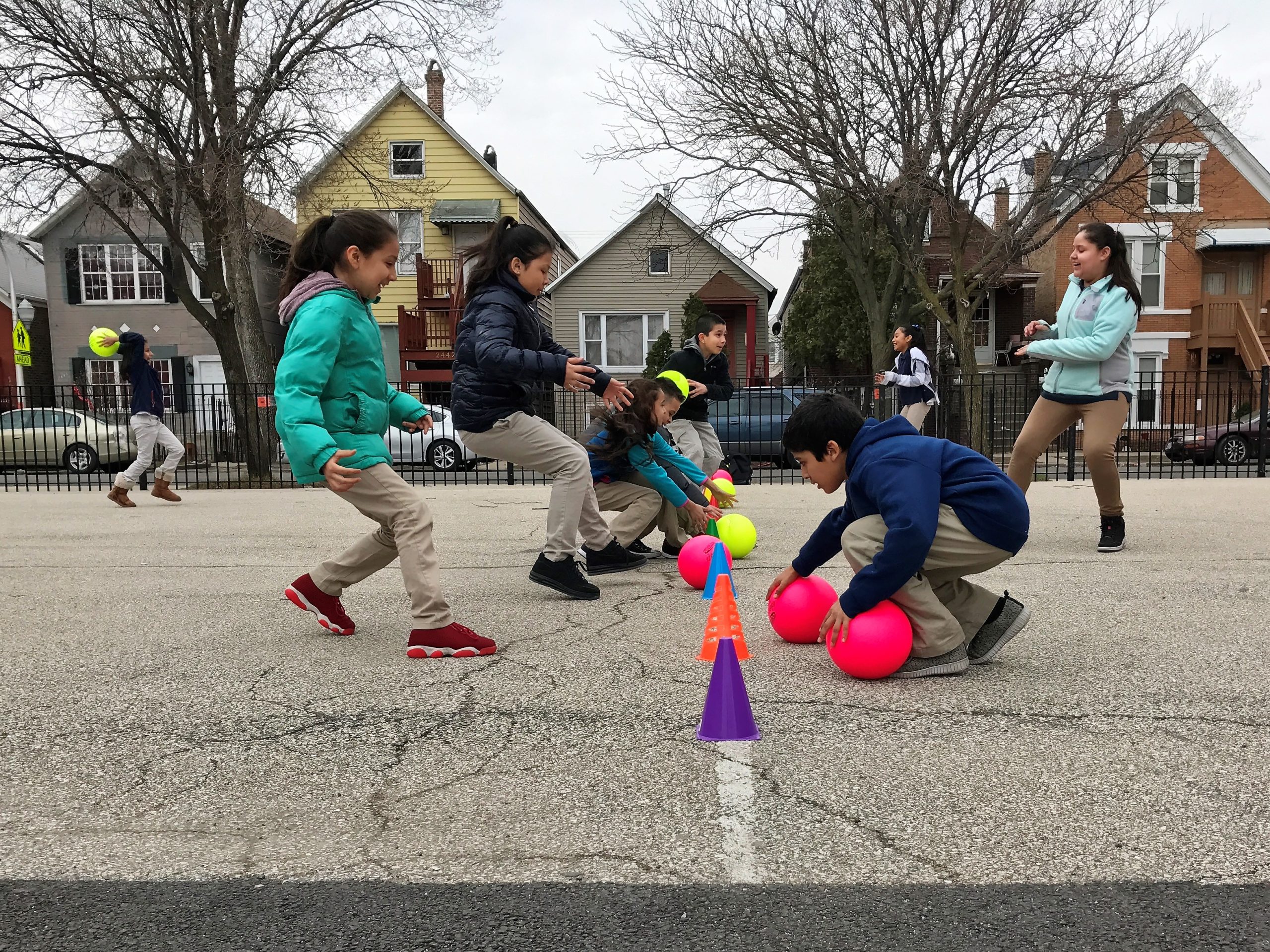 Kids playing with balls and cones