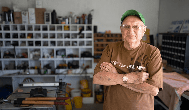a man with arms crossed, smiling