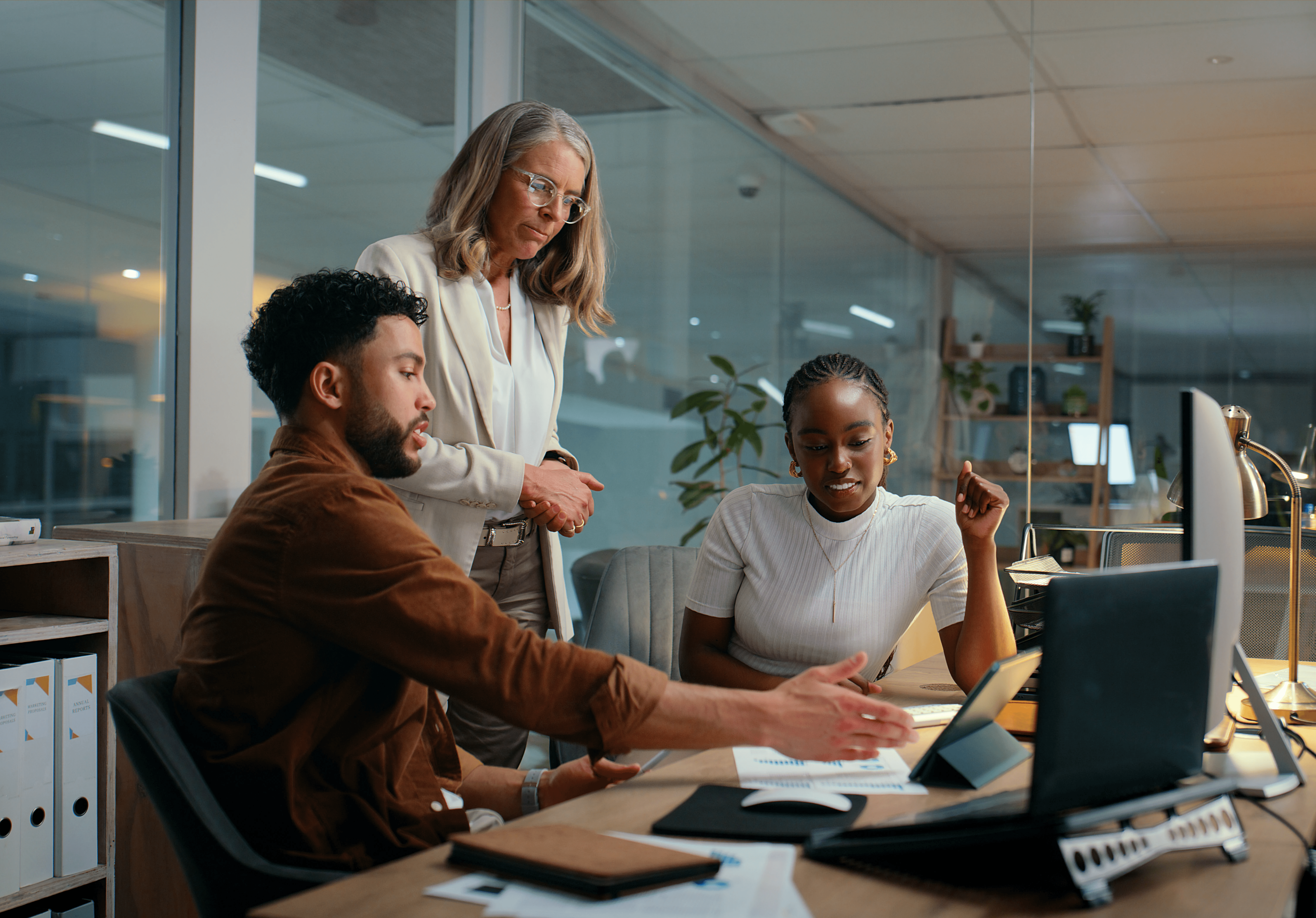 Person smiling while working on a laptop, with icons representing AI-powered research tools around
