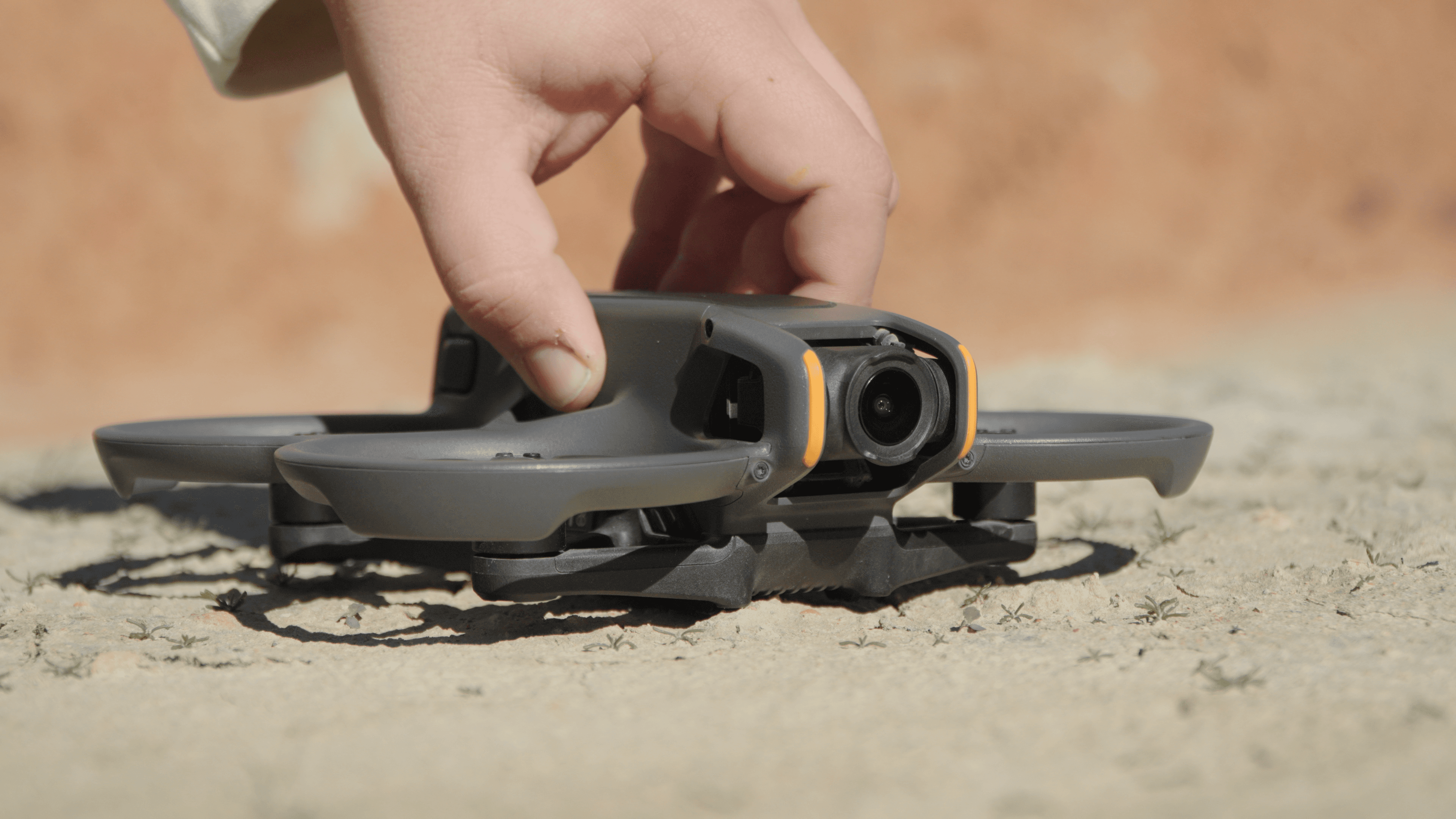 Two filmmakers operate a large camera on a dimly lit set. One wears headphones, both focused, suggesting a serious, creative atmosphere.