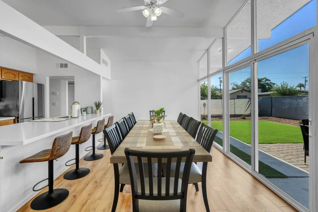 Dining table for the group beside a wall of windows, Retreat Haven in North Las Vegas