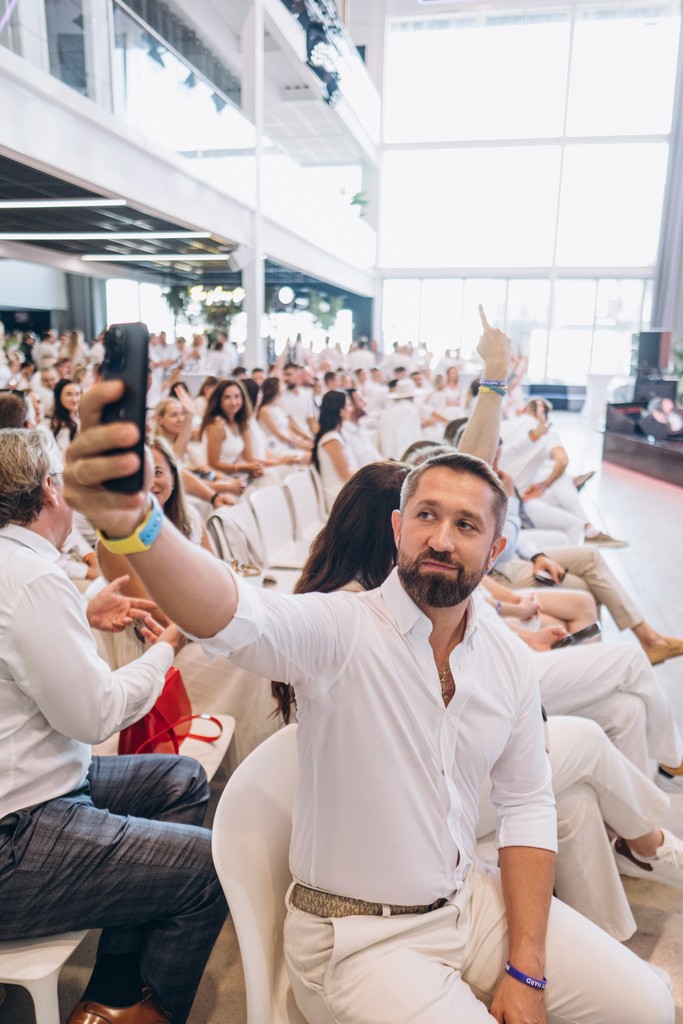A man stading with Surfboard