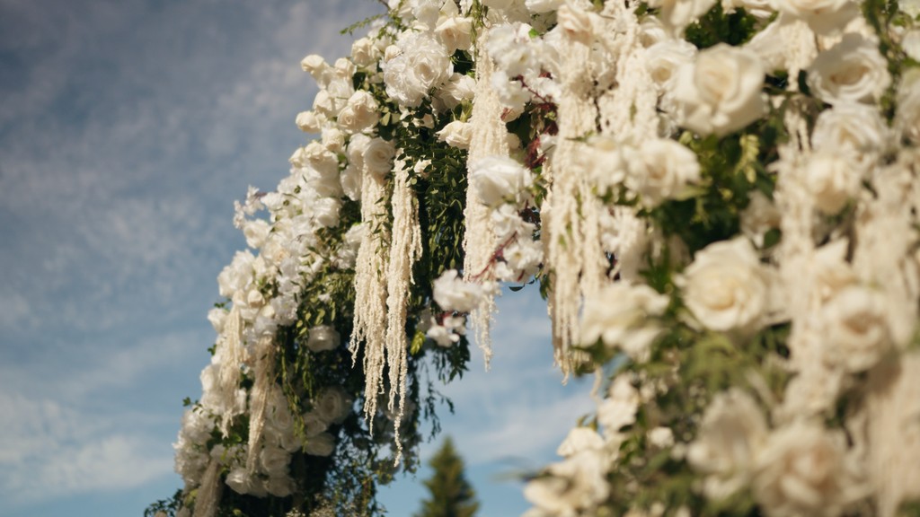 The bride is putting on her earrings.