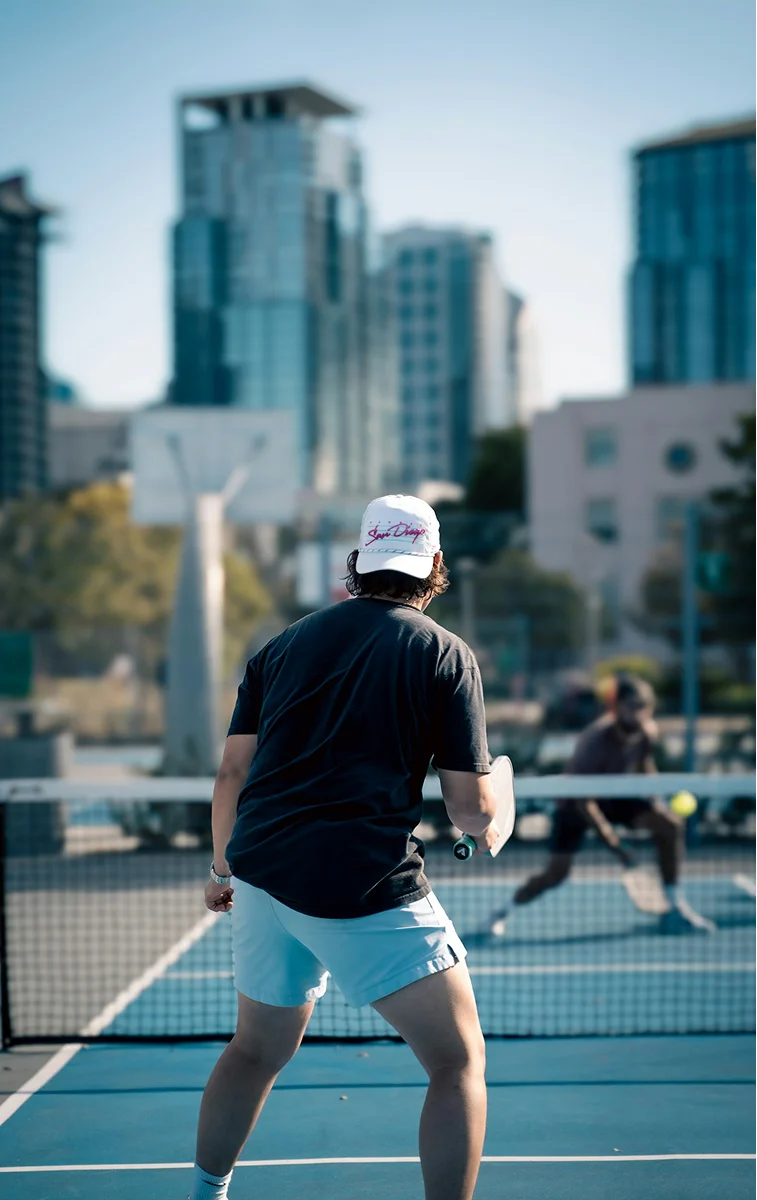Tennis player returning a shot on a clay court