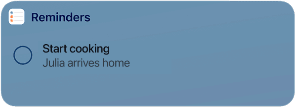 A digital reminder notification displayed on a blue background reads "Start cooking" with "Julia arrives home" beneath it, featuring a circular checkbox icon on the left.