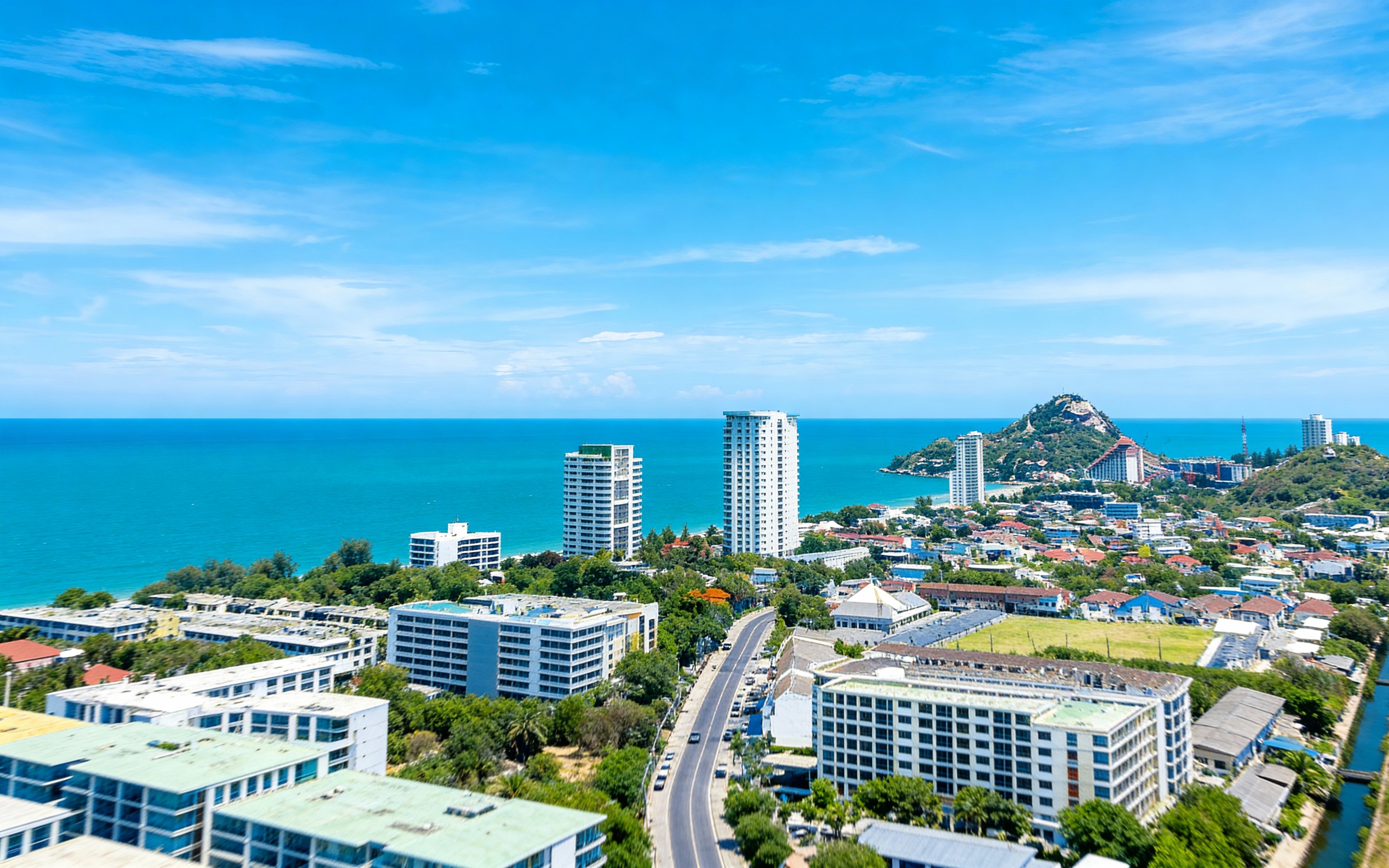 Aerial view of the twin pagodas of Doi Inthanon at sunrise, surrounded by lush gardens, fountains, and mountain scenery, capturing the serene beauty and spiritual essence of Chiang Mai, Thailand.