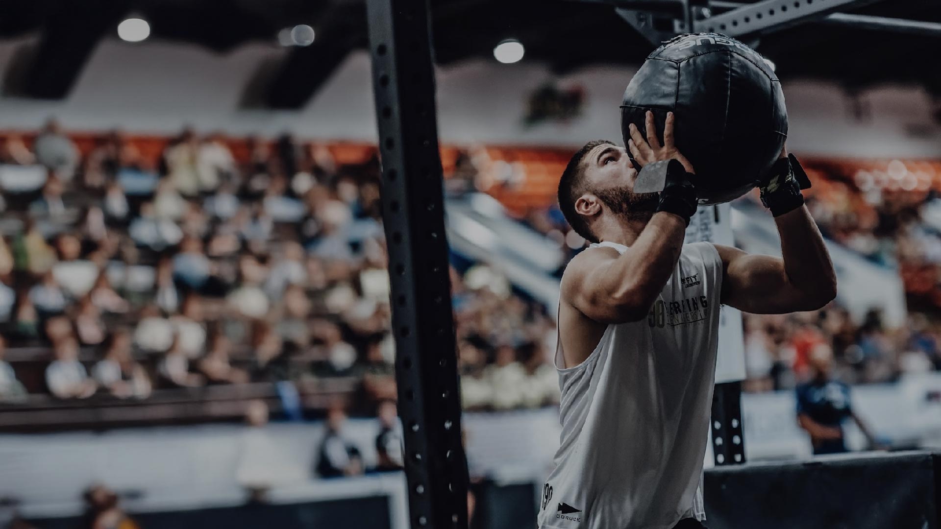 Two individuals are working out in a gym, focusing on dumbbells and strength training equipment.