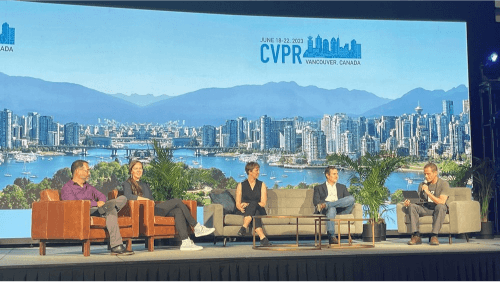 Image of pannelists seated on stage at CVPR