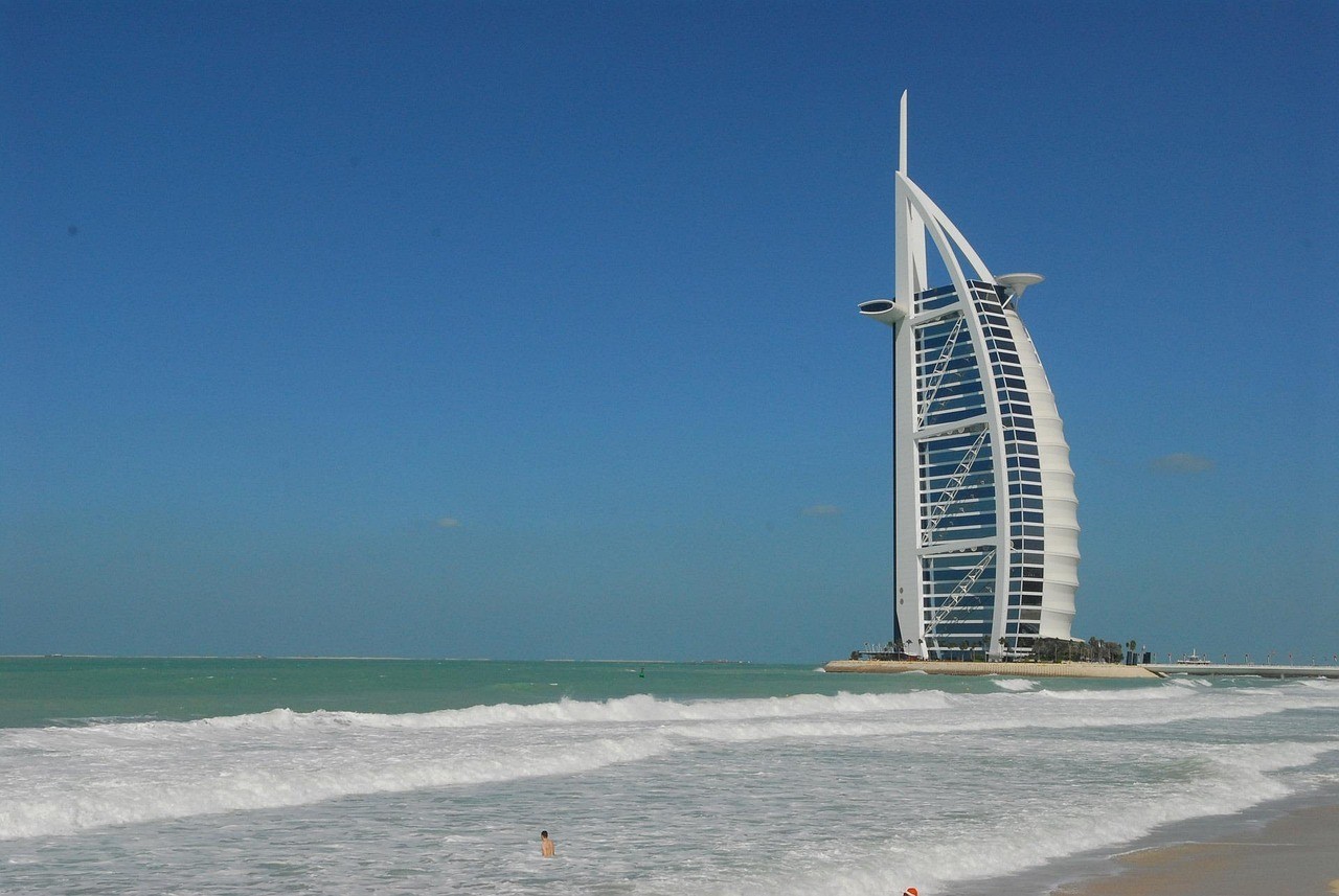 The Burj Al Arab in Dubai with waves rolling onto the beach in the foreground.&nbsp;