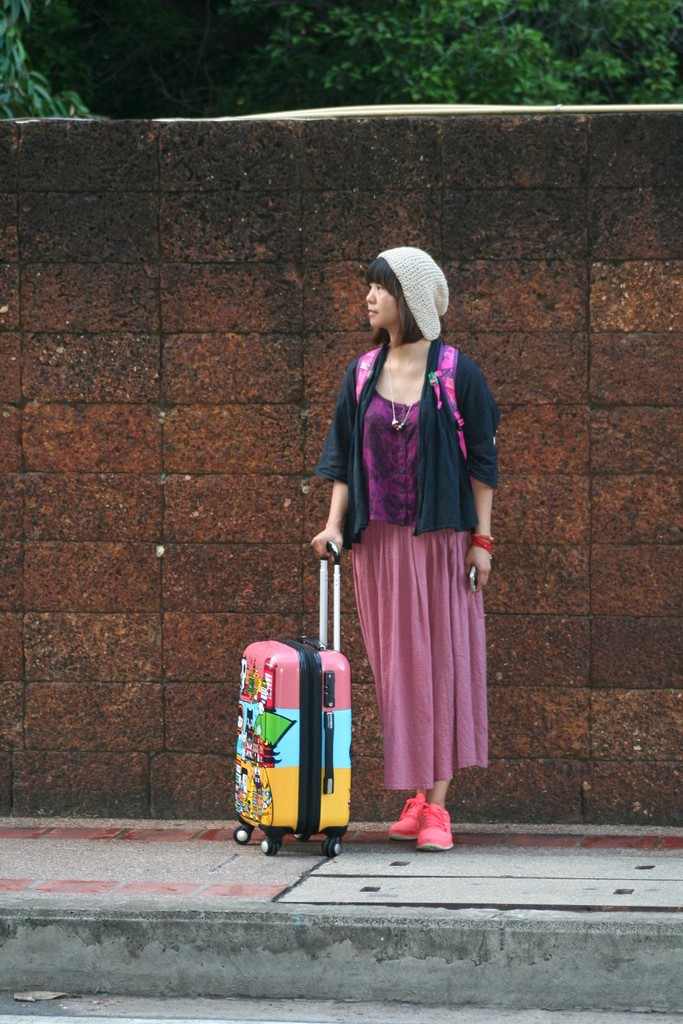 New immigrant arriving in Canada with colorful luggage ready to start their settlement checklist