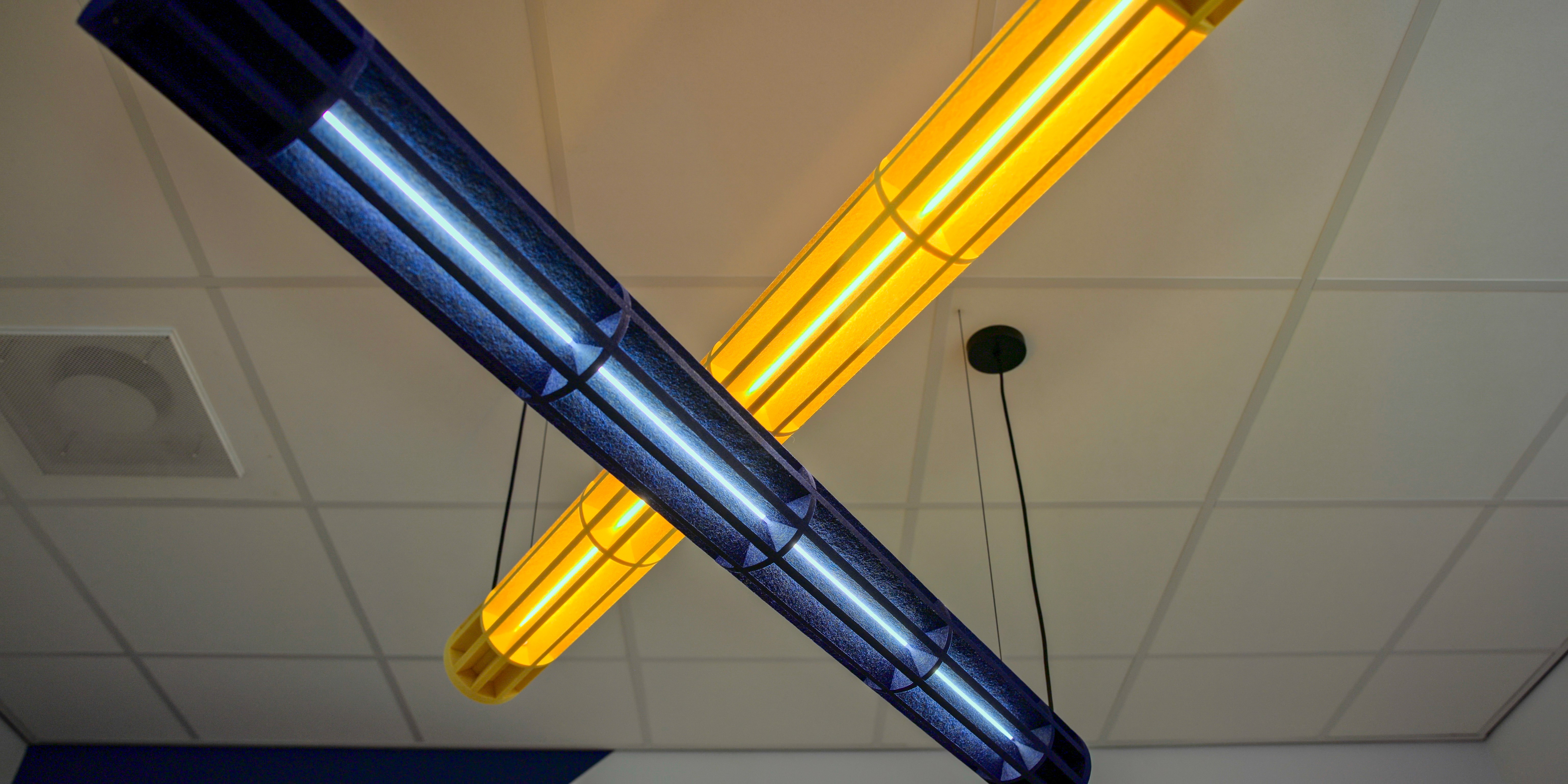 Detailopname van blauwe en gele verlichtingsarmaturen in kantoor Oostendorp Nederland