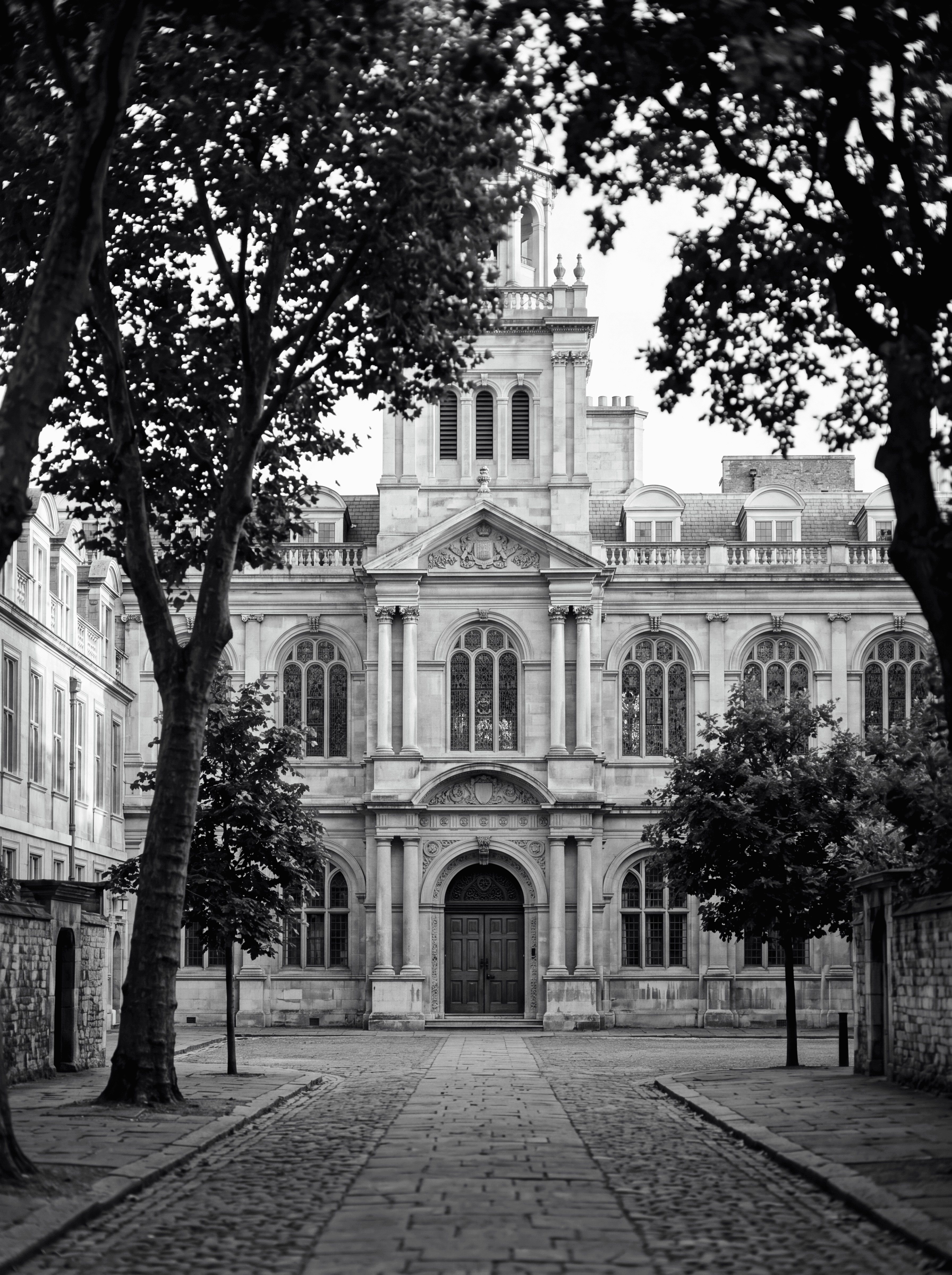 Classical exterior of a prestigious London independent school in early morning light, illustrating top private school placement for international families, monochrome editorial photograph