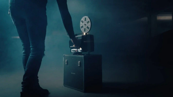 A man operating a vintage film camera