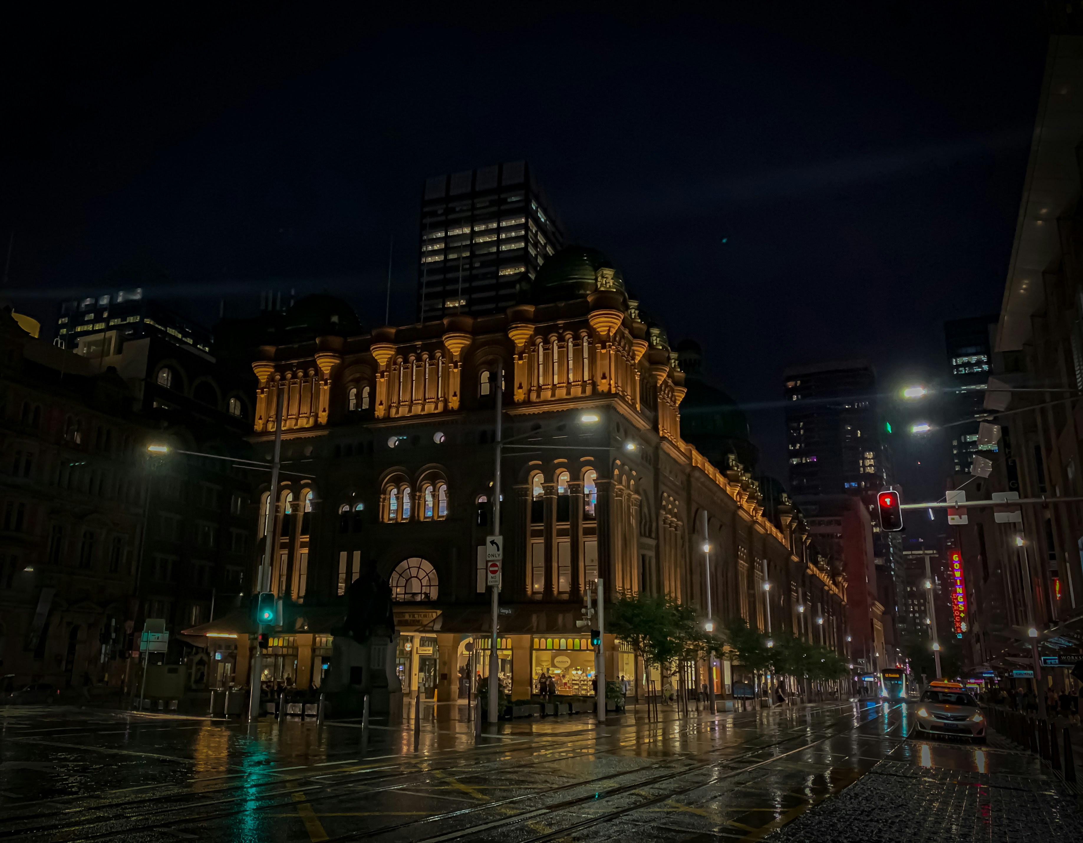 people walking on street near brown concrete building during nighttime