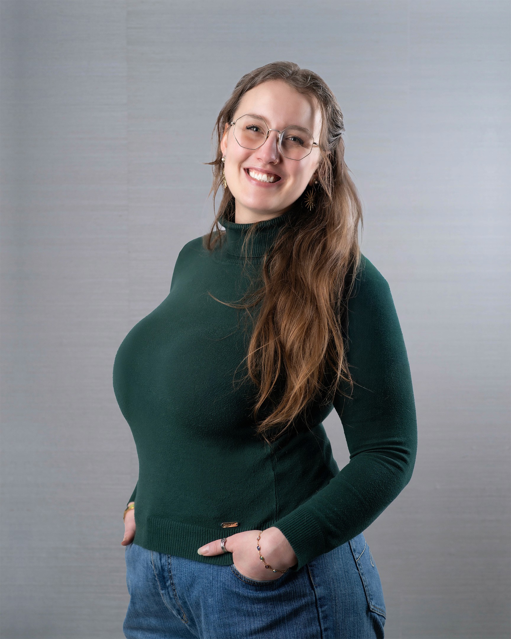 Young woman with glasses smiling.