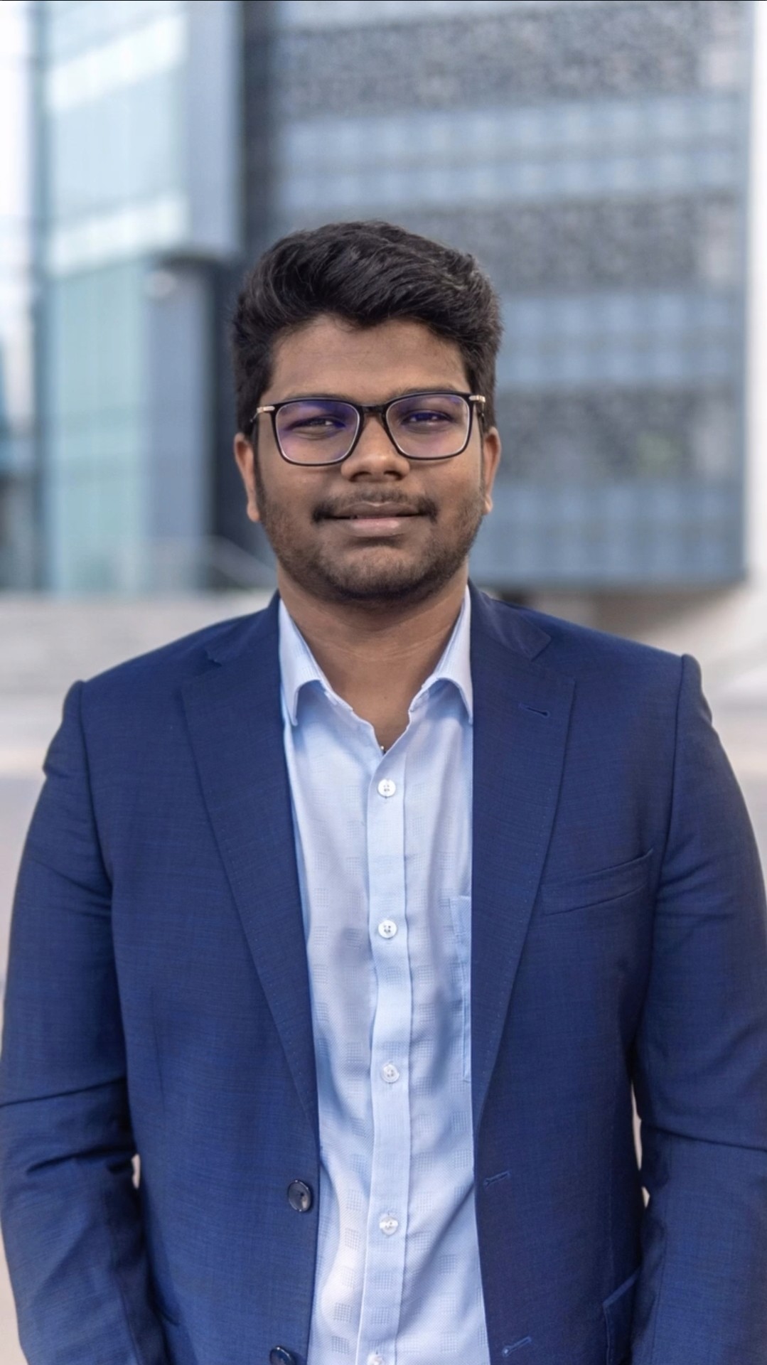 Profile portrait of a man in a white shirt against a light background