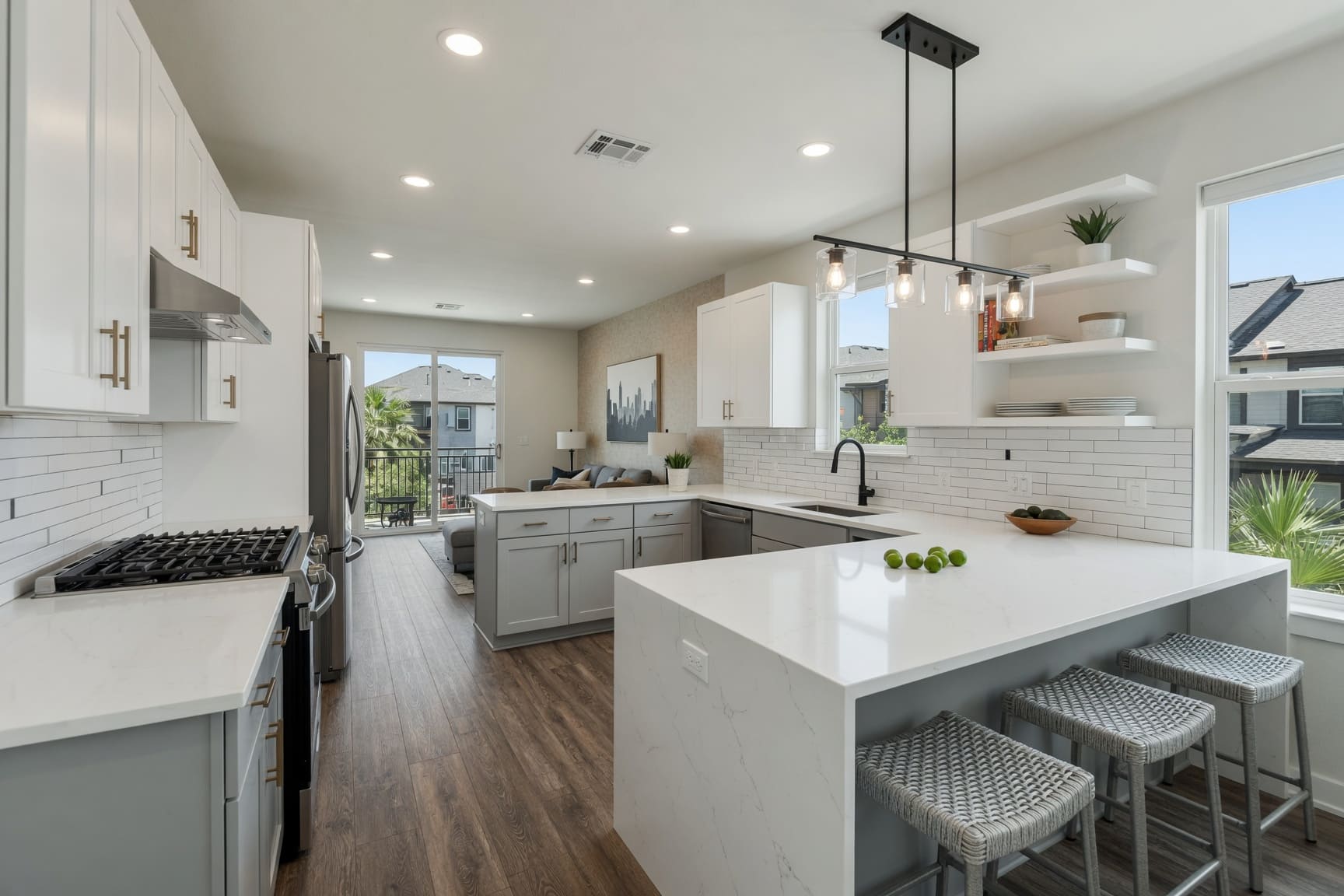 Kitchen with white island, grey cabinetry, and open shelving
