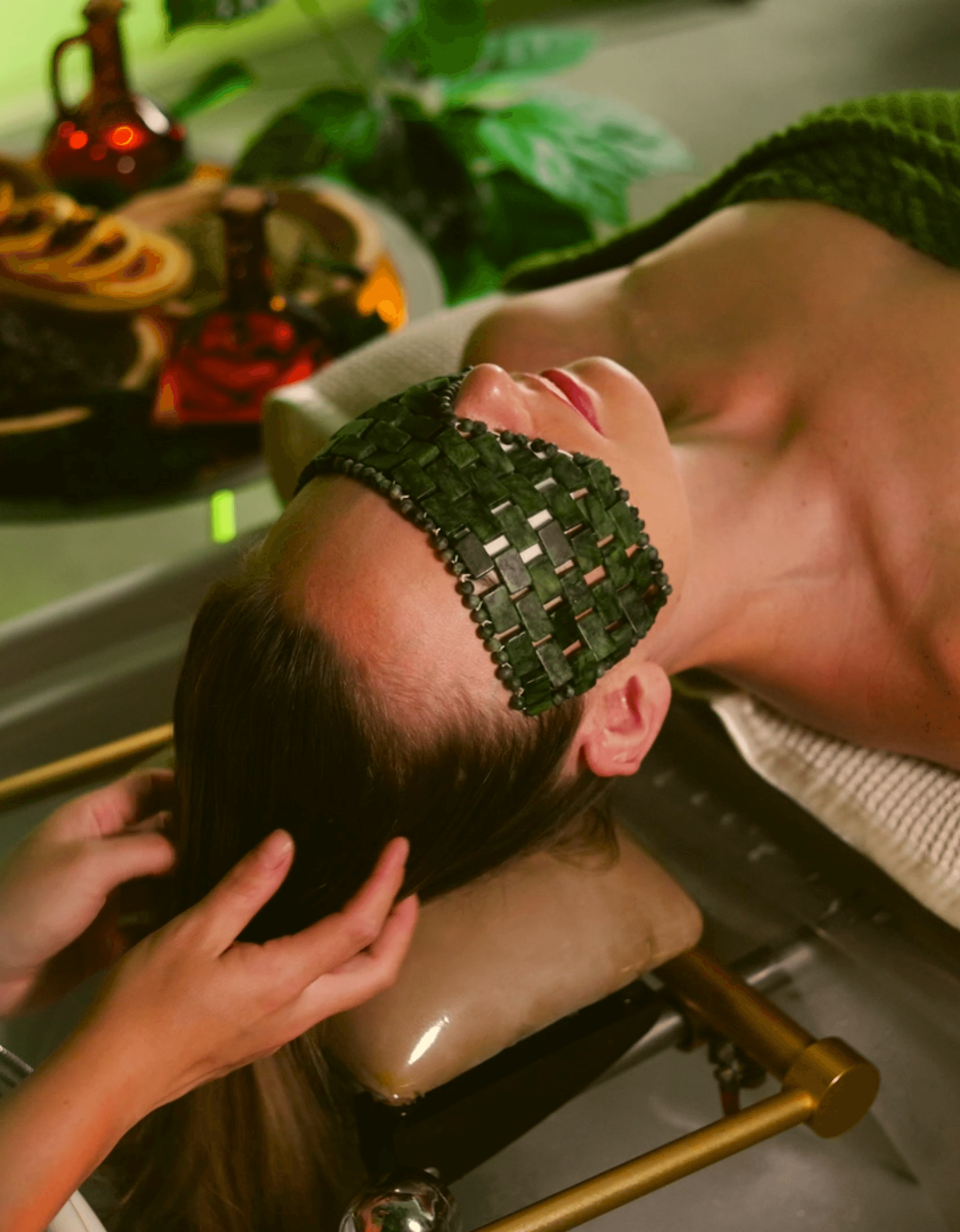 Žena dostávájí masáž hlavy s kamennou maskou