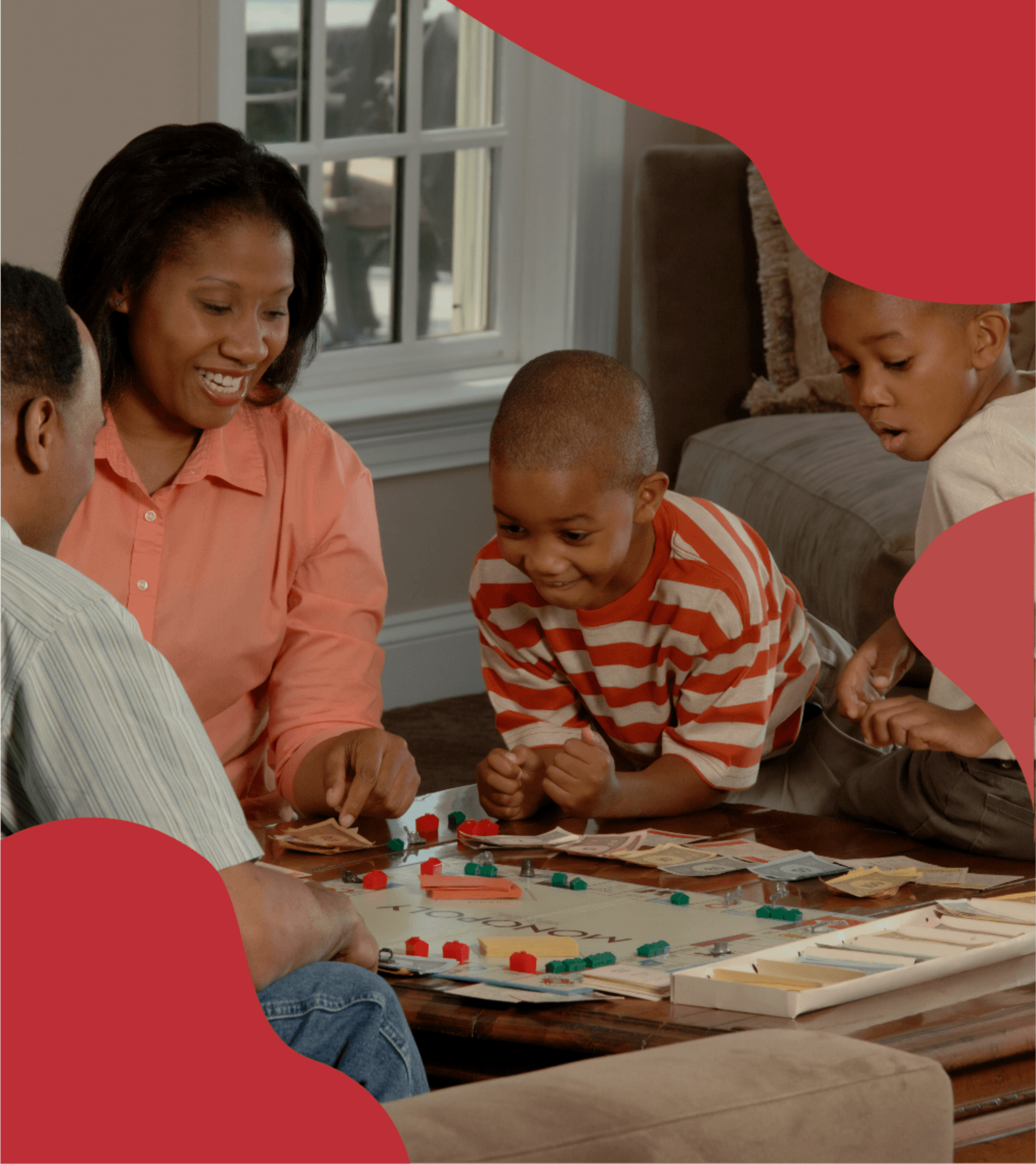 A family of four sits around a living room coffee table, enjoying an engaging board game together, fostering bonding and fun in a cozy home setting.