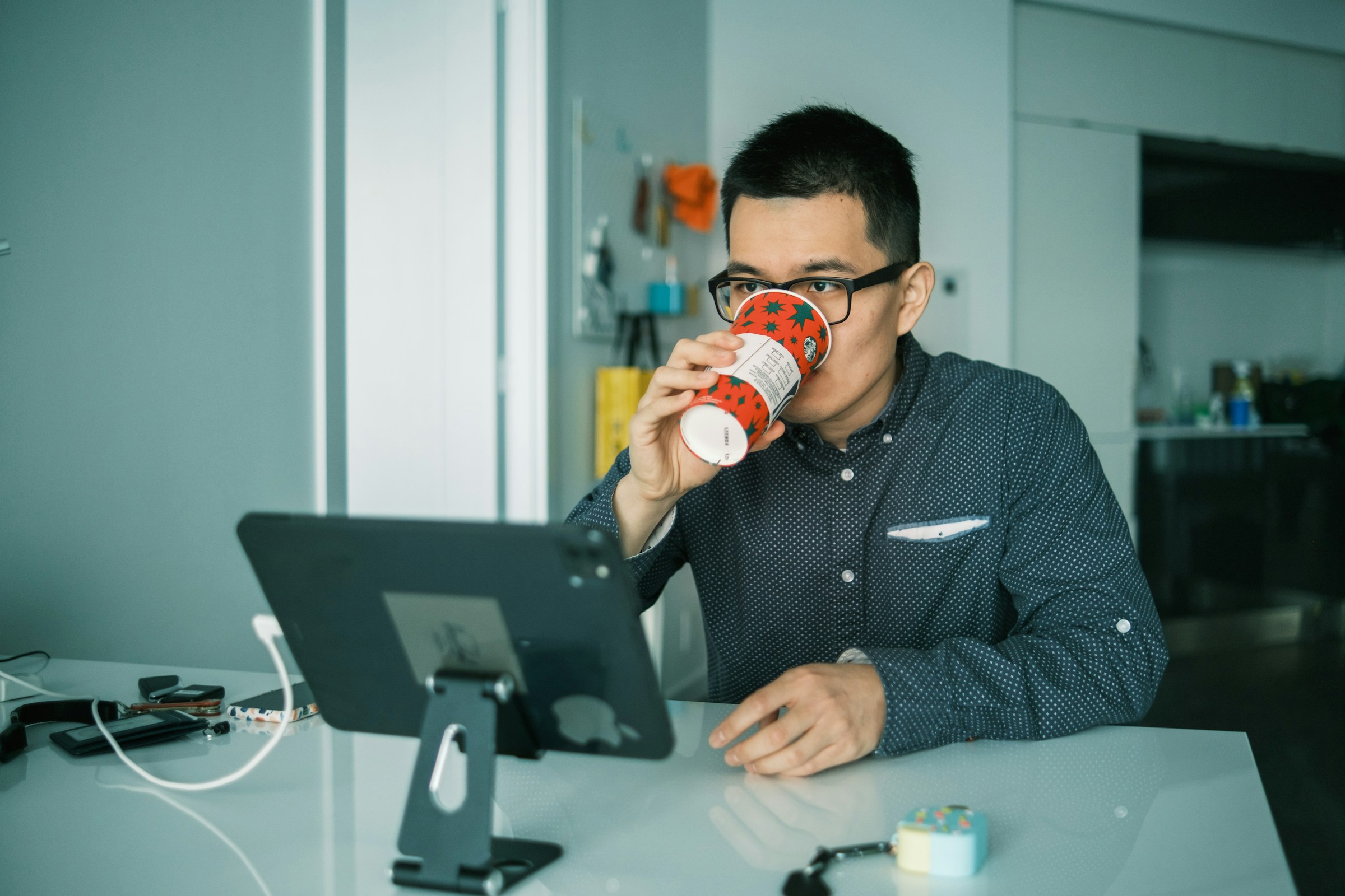 man working and drinking coffee - How to Add a Page on Shopify