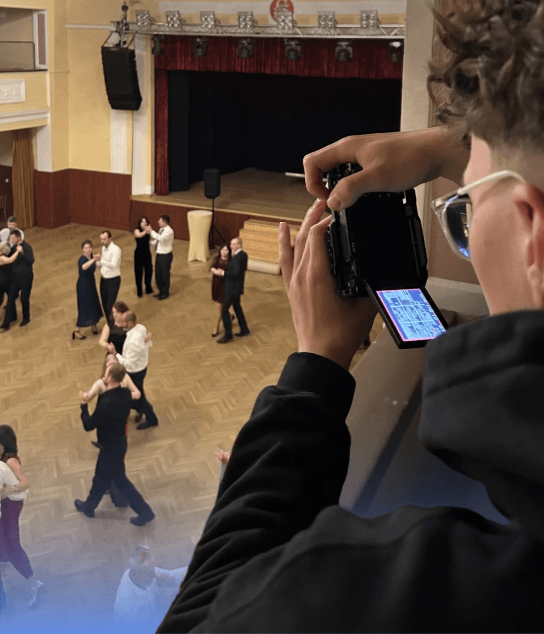Hand using laptop trackpad beside open color swatch book