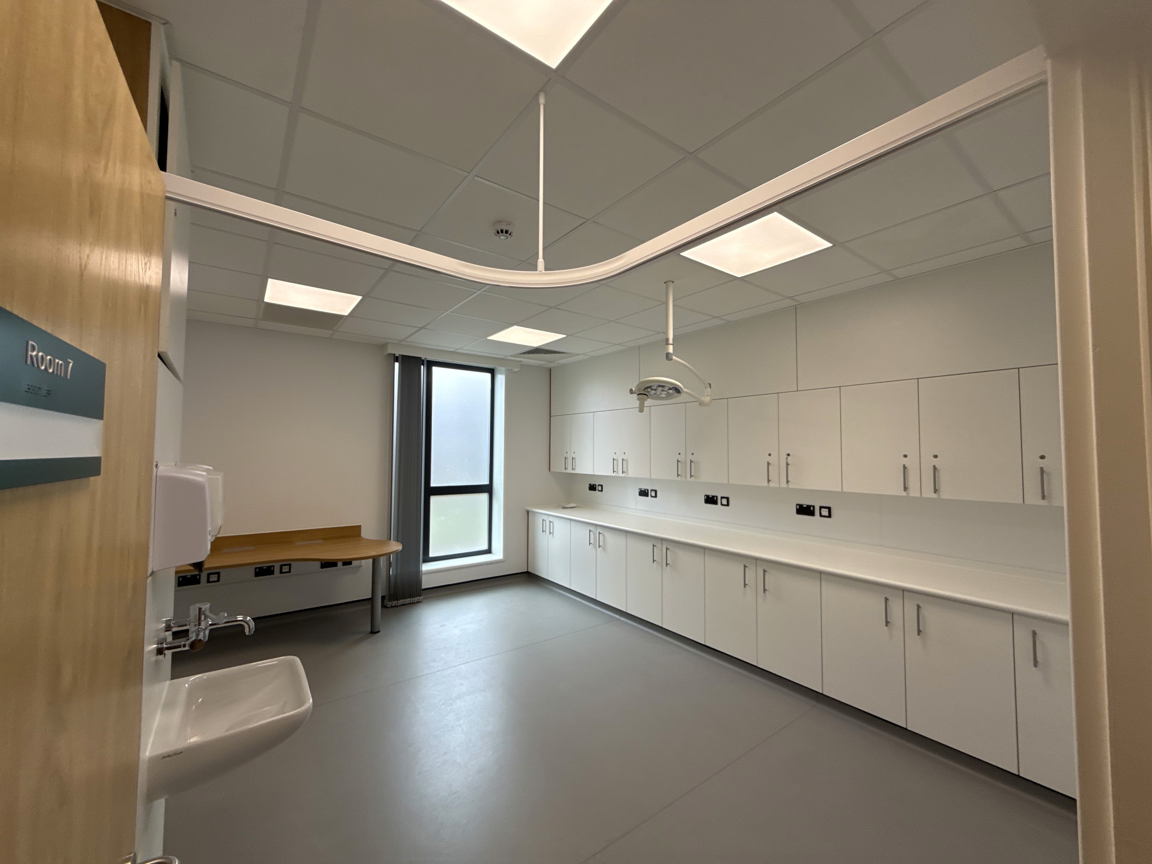 Fitted consulting room with examination light, ceiling curtain track and bespoke desk, Marsh Court Health Centre