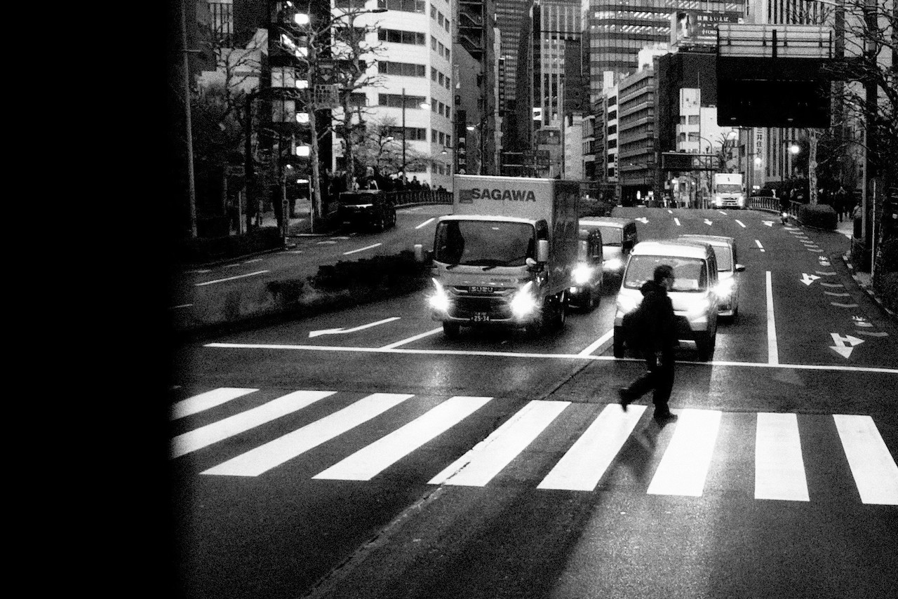 pedestrian crossing roads while the lights are red
