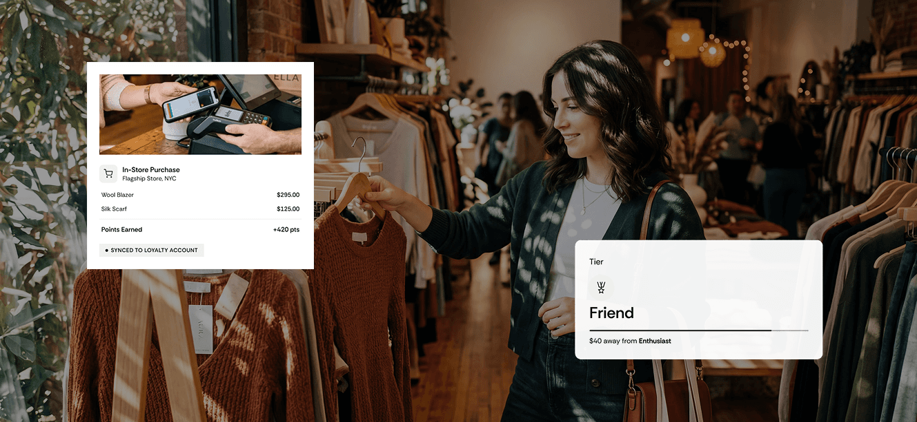 Laptop displaying a website design alongside a gift and shopping bag on a wooden desk. 