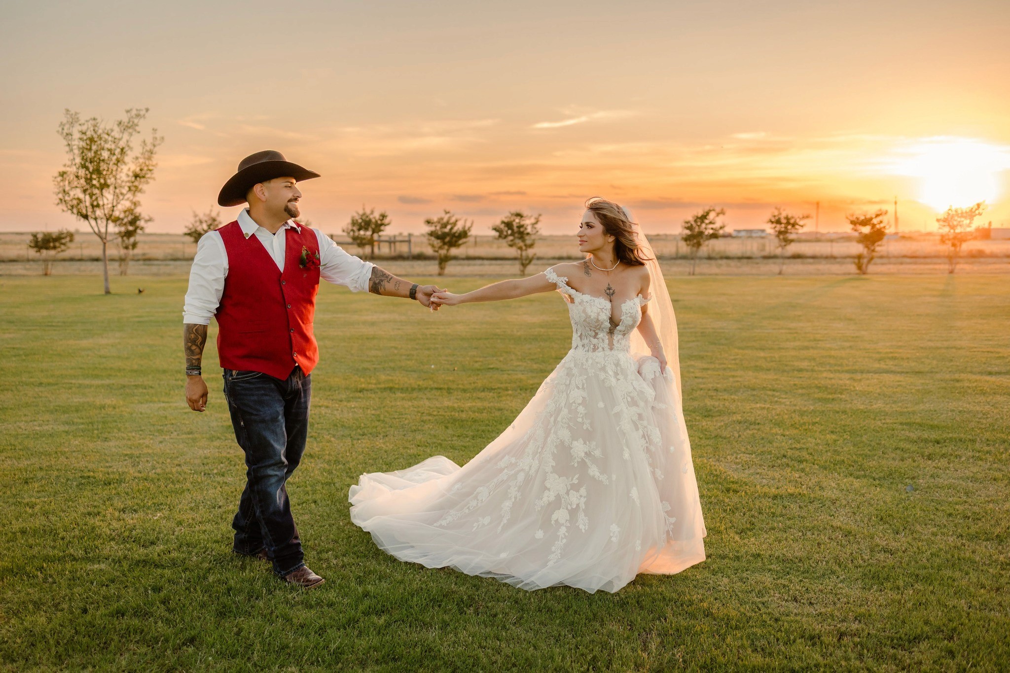 A couple in formal wedding attire embraces intimately in a vast.