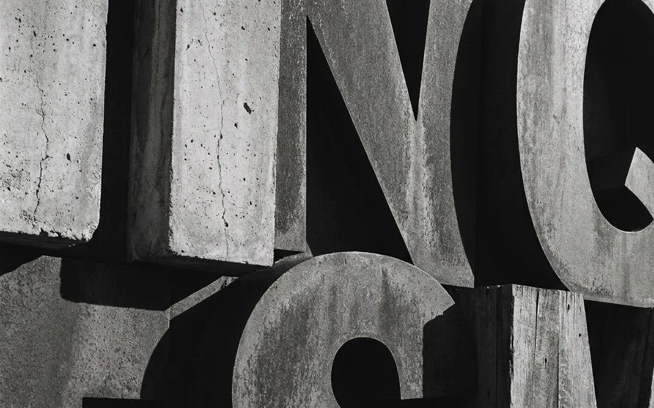 Concrete letterforms in hard light, black and white