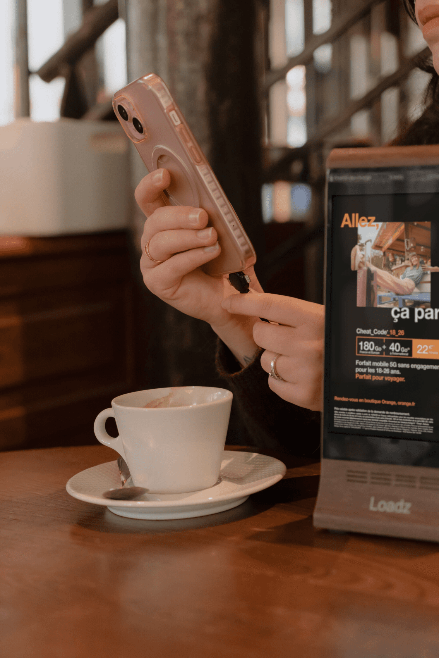 A young man in a white shirt and tie sits on the floor, surrounded by scattered papers. He looks down at a document, appearing focused and pensive.