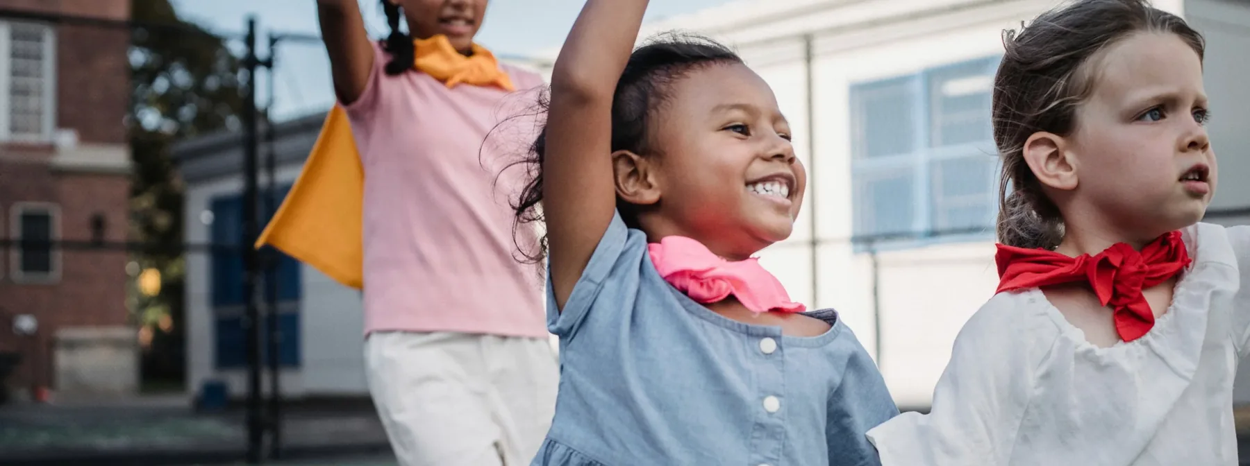 Kids cheering and laughing on a playground