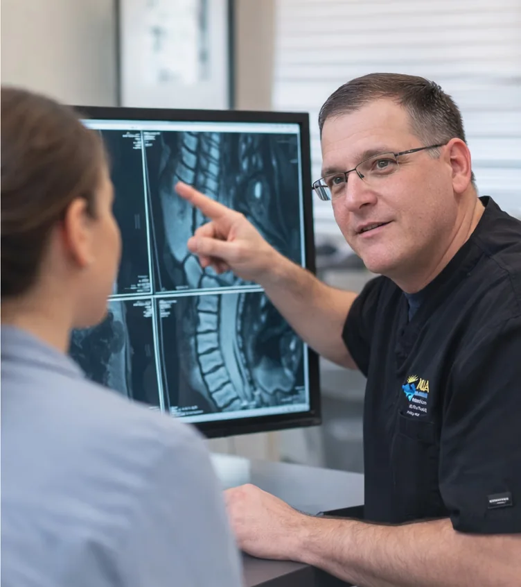 Dr. Kaldy reviewing MRI imaging with a patient