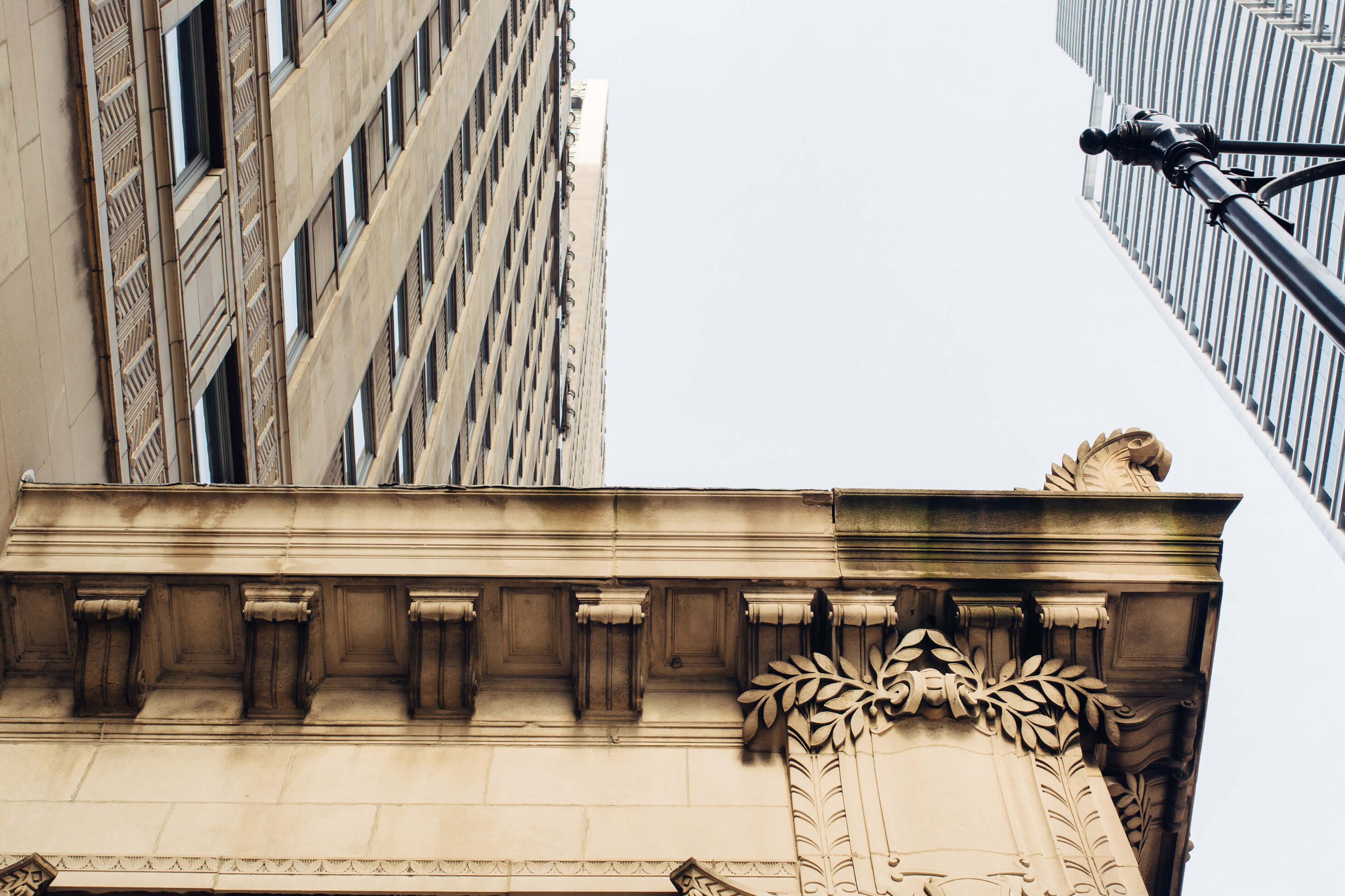 Black and white image of people working at a table with laptops, showing hands gesturing during discussion of digital content displayed on screens, with fabrica® logo in the corner.