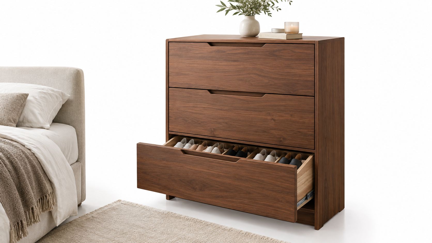 A modern wooden shoe rack drawer unit with three storage levels placed beside a beige bed.