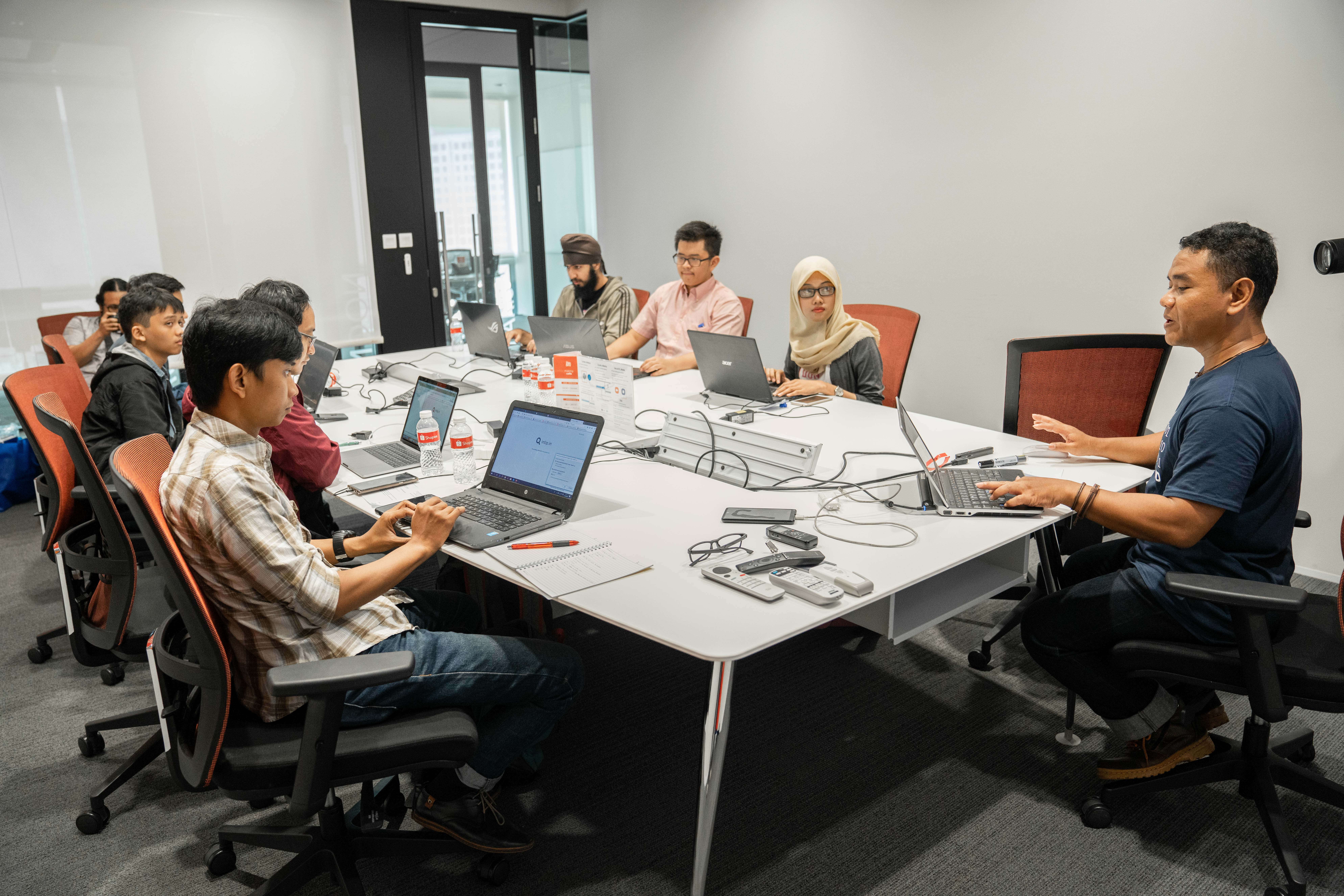 Two colleagues collaborating on a laptop in office.