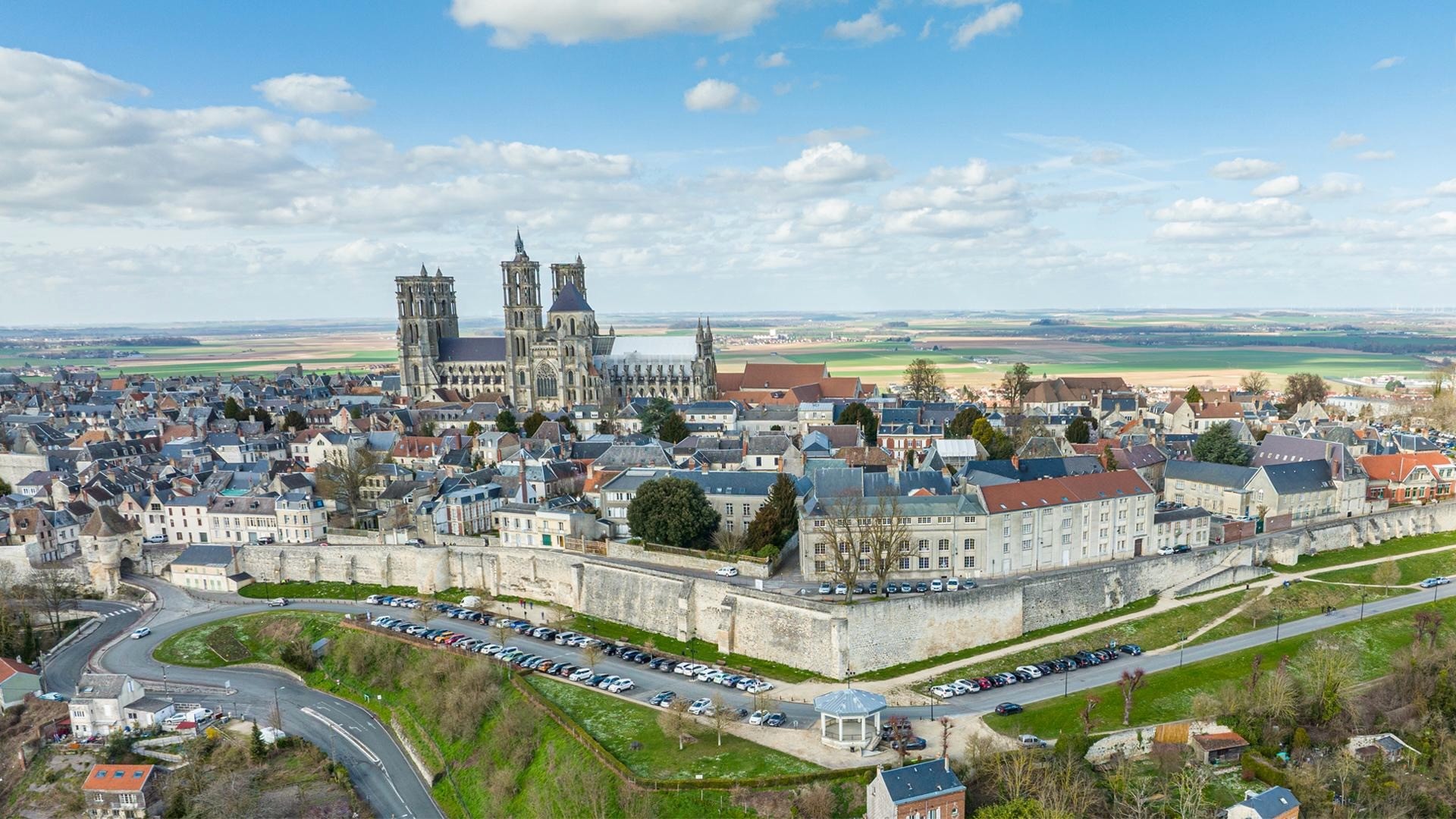 An aerial view of Laon on its hill, the cathedral towers rising over the town and plain.