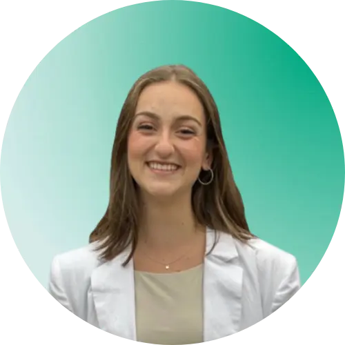 Woman in white blazer smiling.