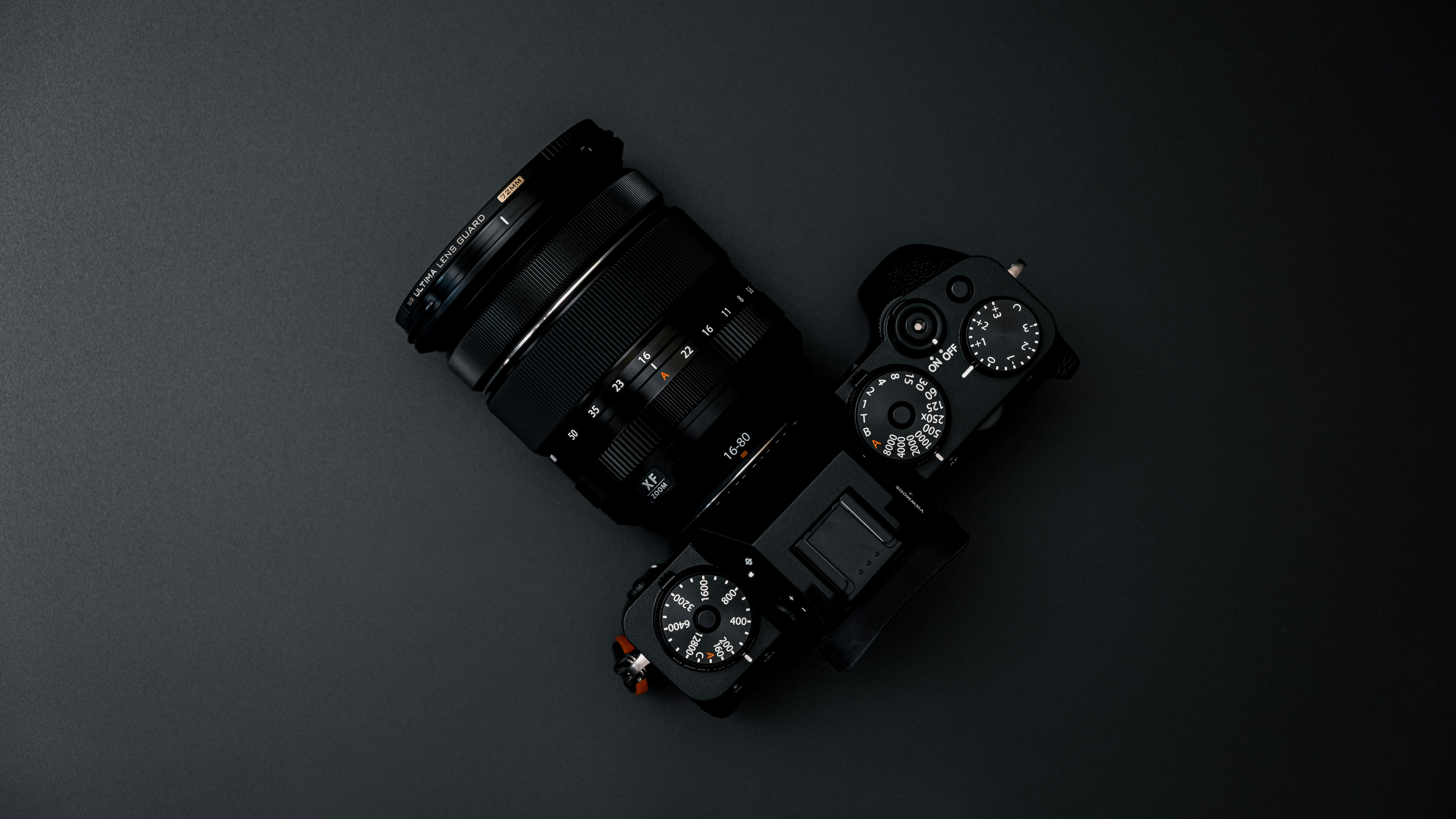 black dslr camera on gray surface