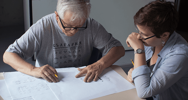 man teaching type to female student