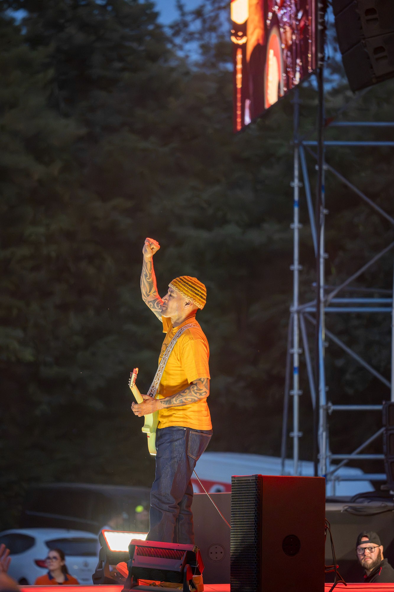 Duo de guitaristes en tenue jaune sur scène, ambiance de fin de concert