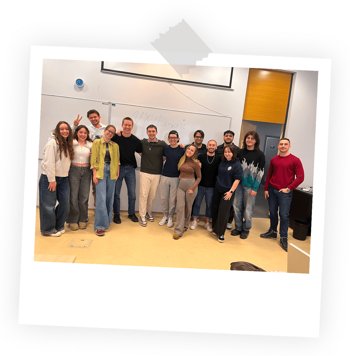 a group photo of Phil and designer students in a classroom