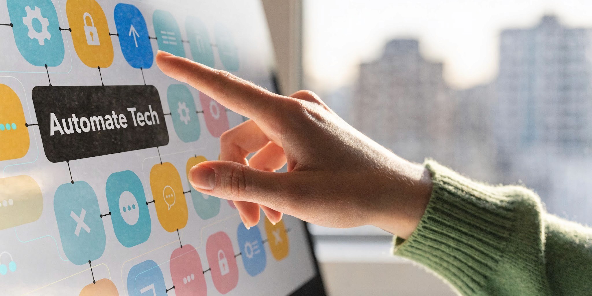 A close-up view of a person pointing at a screen displaying a digital workflow chart titled Automate Tech.