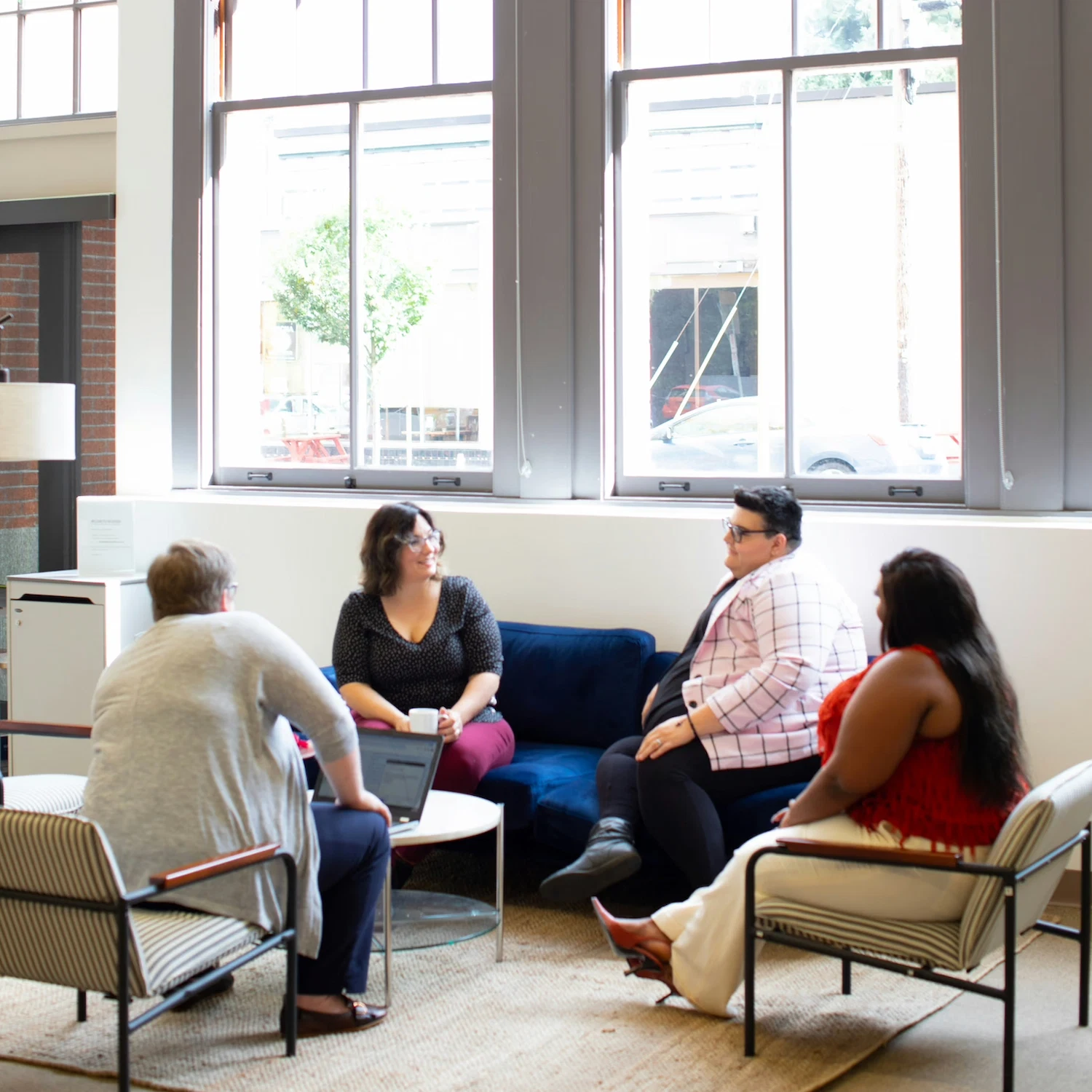 Diverse group of people sitting in a supportive circle during an in-person group therapy session in New York City, focusing on connection and healing.
